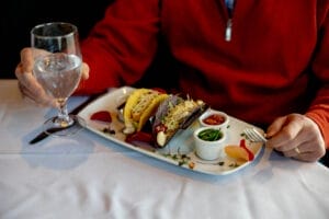 A plate with tacos and sauces